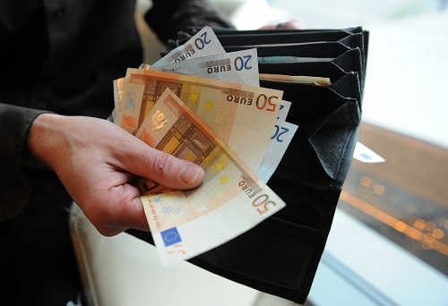 A Slovak counts euro bills after a withd